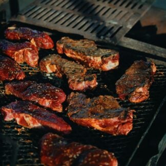 Hanger steaks on a grill.